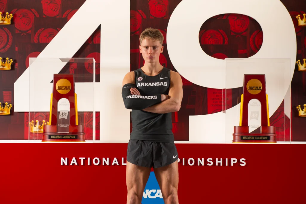 Student-Athlete Sebastian in front of trophies