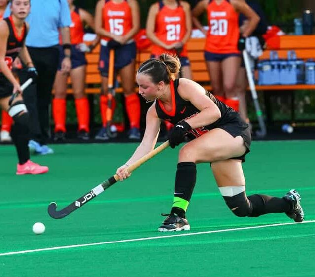 Hockey player Ella Cashman playing on a green field.